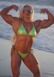 Amazing Muscle Babe posing outdoors