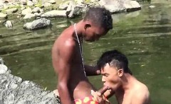 Teen gay swimmer playfully going down in the river