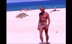 Tanned guy on beach in tiny string thong (temporarily!)